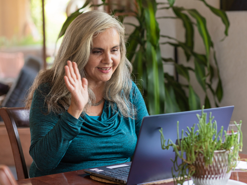 Mature woman on a video conference on laptop at home