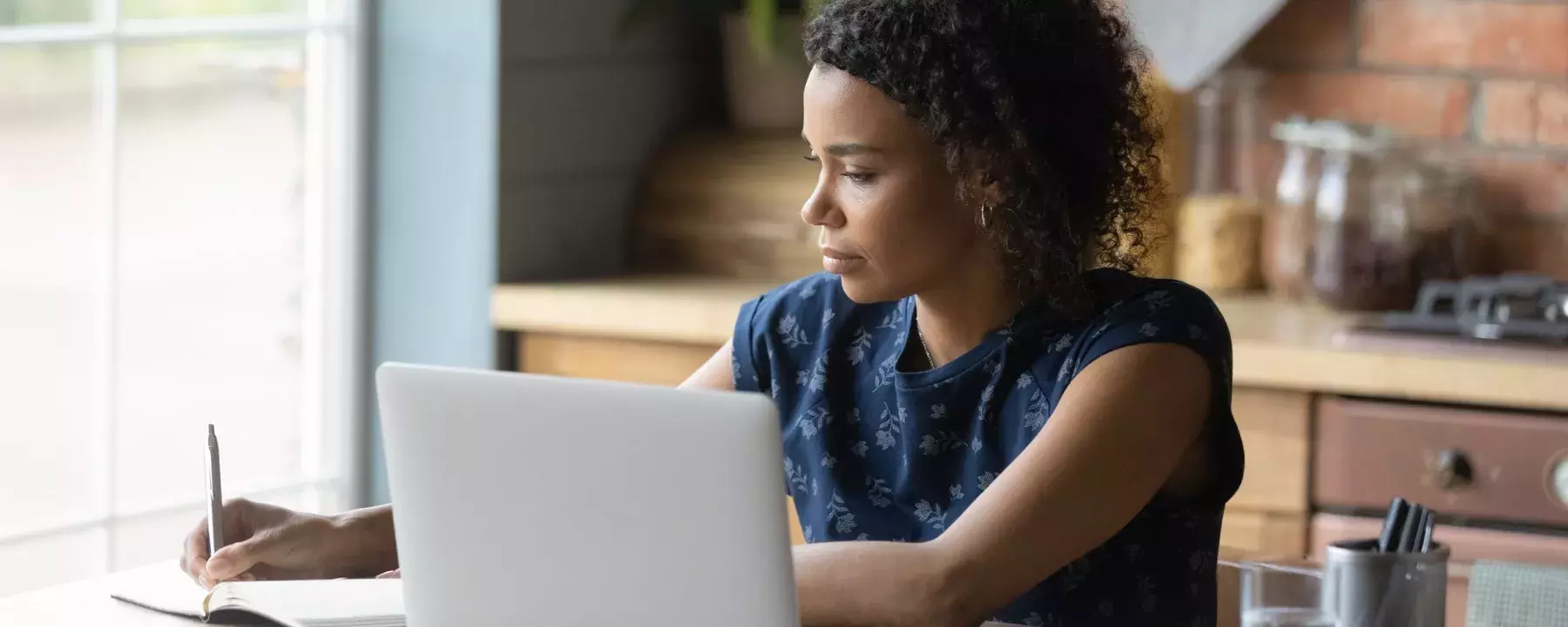 College student doing some home works from home with laptop